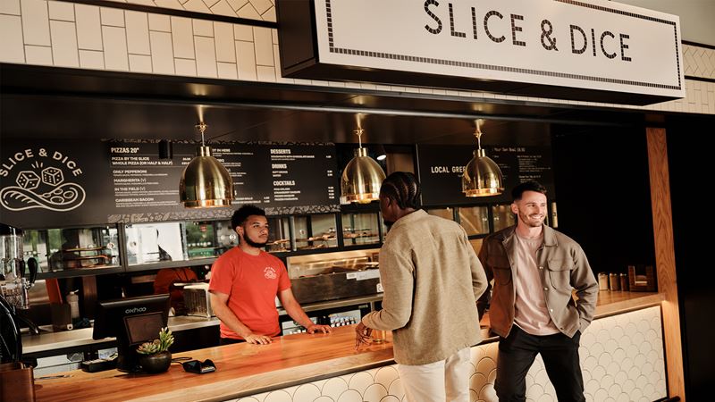 Fill up on your choice of foodie delights at Fulham Pier's Riverside Market. Credit: Fulham Pier. Image courtesy of Fulham Pier. Two men collecting pizza from Slice & Dice at Fulham Pier