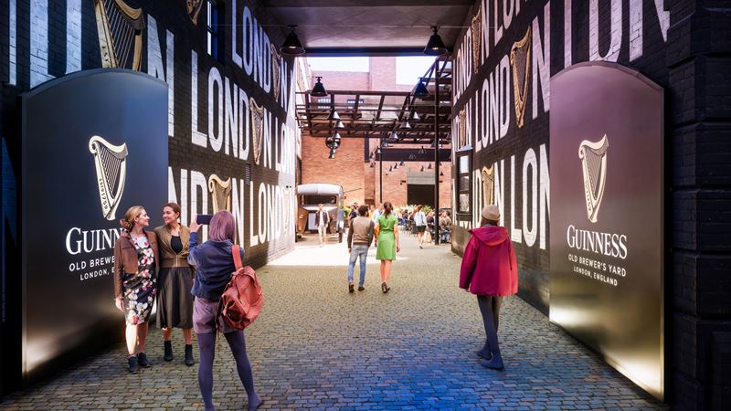 Discover London's newest hangout for beer lovers. Credit: Guinness Open Gate Brewery. Image courtesy of Guinness Open Gate Brewery. People entering London's new Guinness Open Gate Brewery's courtyard on a clear sunny day.