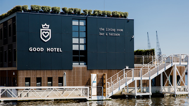 Good Hotel London. Credit: Good Hotel London. Image courtesy of Good Hotel London. Dark blue front of contemporary floating hotel on the river Thames.