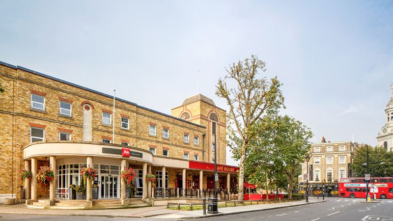 Walk straight out onto the main high street's shops and restaurants from Ibis London Greenwich. Credit: Visit Greenwich. Image courtesy of Visit Greenwich. A photo of the exterior of Ibis London Greenwich with a view of Greenwich high street in the background