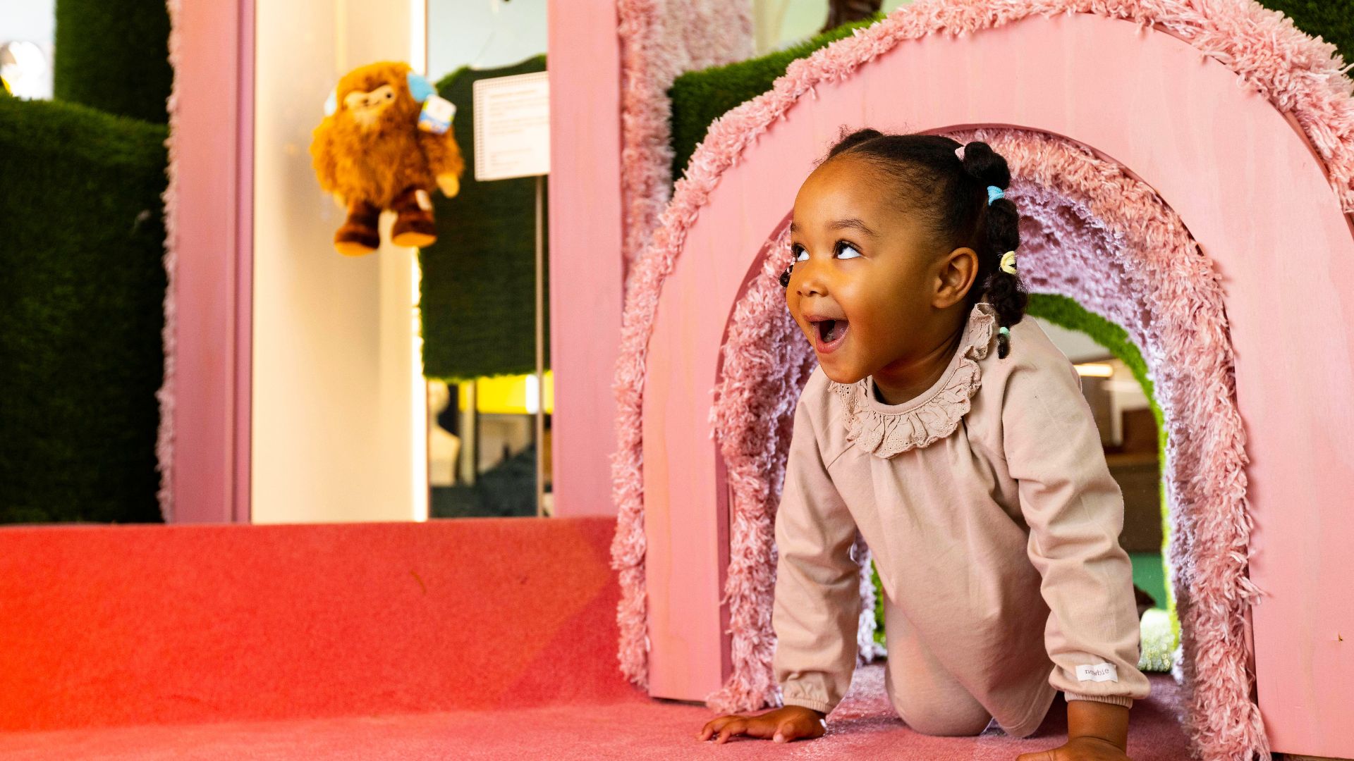 A toddler plays in the soft pink sensory tunnel in the Play area at Young V&A. © David Parry courtesy of Victoria and Albert Museum, London Toddler crawling through a soft pink play tunnel in the sensory play area at Young V&A.