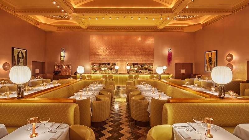 Enjoy the romantic setting of Sketch The Gallery restaurant. Credit: Edmund Dabney. Image courtesy of Sketch. The yellow and gold interior of Sketch The Gallery restaurant showing the main seating area with the bar in the background.
