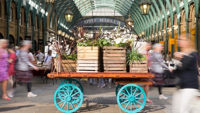 Covent Garden's Apple Market. Image courtesy of Brendan Bell. A cart topped with green plants in the middle of Covent Garden's Apple Market.