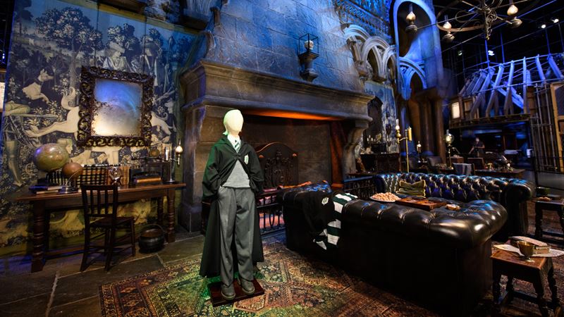 Draco Malfoy costume in the Slytherin common room. Credit: Warner Bros. Studio Tour London – The Making of Harry Potter. Image courtesy of Golden Tours. Draco Malfoy costume in the Slytherin common room at Warner Bros. Studio Tour London.