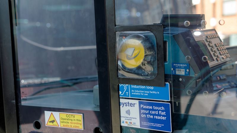 Simply tap your phone, card, Oyster or show your ticket for travel on a London bus. Credit: Shutterstock. Image courtesy of Shutterstock. A photo of a yellow contactless London bus card reader next to the driver seat