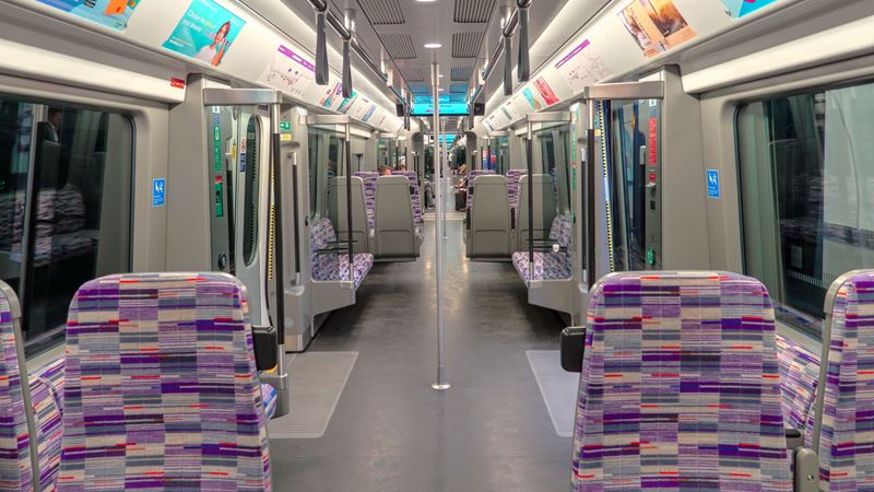 Travel on a state-of-the-art Elizabeth line train during your journey around London. Credit: Shutterstock. Image courtesy of Shutterstock. A photo of an empty Elizabeth line train with its purple patterned seats and modern interior