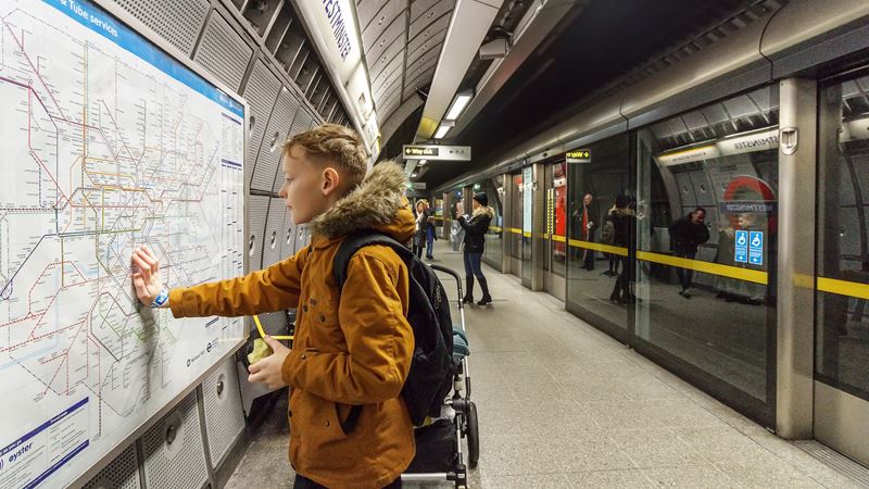 Find out whether your children need an Oyster card to ride the London Underground. Credit: Shutterstock. Image courtesy of Shutterstock. Young boy looks at a map of the London Underground in a Tube station.