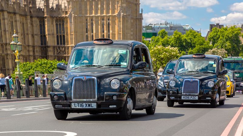 Round up taxi fares instead of calculating percentages. Credit: Shutterstock. Image courtesy of Shutterstock. A photo of three black taxi cabs driving past the Houses of Parliament in Westminster