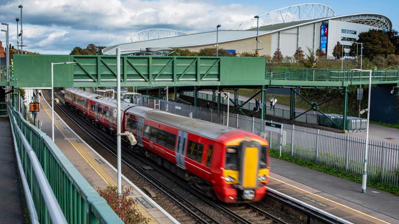 Choose from several transport options to London including the Gatwick Express. Credit: Shutterstock. Image courtesy of Shutterstock. A photo of a red and yellow Stansted Express train from above driving through a station