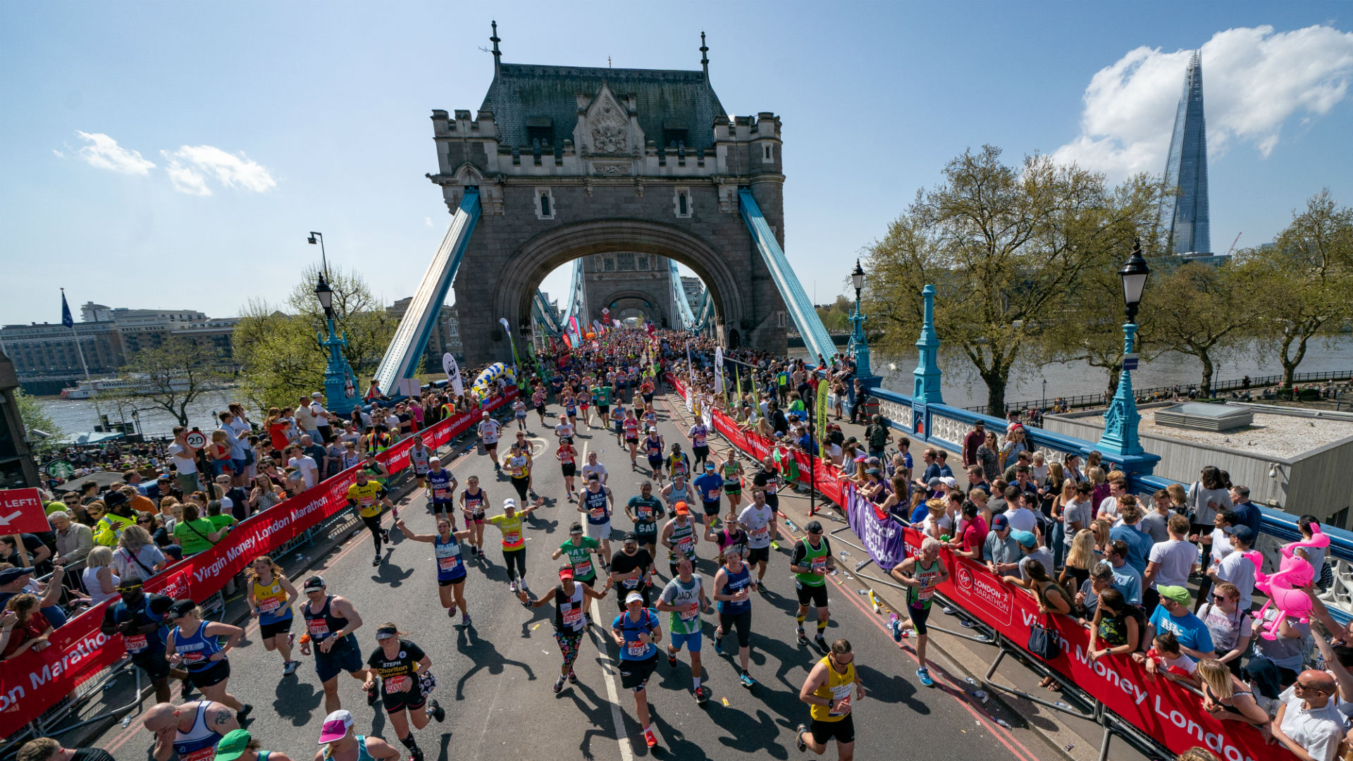 Virgin Money London Marathon 2018. Image courtesy of Virgin Money London Marathon/Bob Martin.. Crowds running over Tower Bridge during the Virgin Money London Marathon