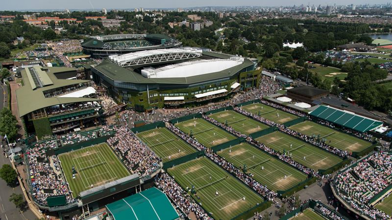 An aerial view of the Grounds with the London skyline in the background on the fourth day of play at The Championships 2017 at The All England Lawn Tennis Club, Wimbledon. Day 4 Thursday 06/07/2017. Credit: AELTC/Bob Martin. Image courtesy of AELTC. An aerial view of the Grounds with the London skyline in the background on the fourth day of play at The Championships 2017 at The All England Lawn Tennis Club,