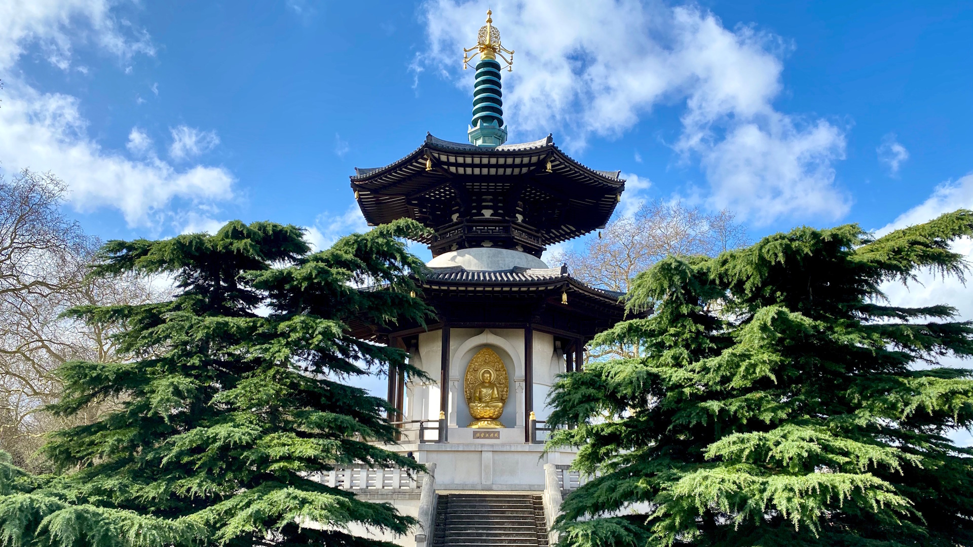 Admire the pagoda at Battersea Park. Credit: Shutterstock. Image courtesy of Shutterstock. The pagoda at Battersea Park with trees on either side and clear blue skies.