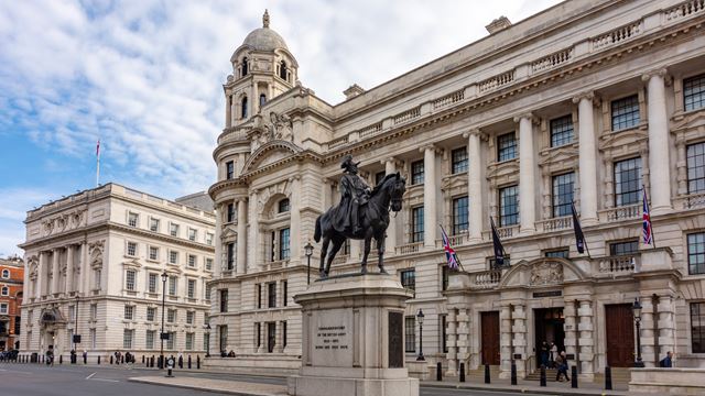 The grand architecture of Whitehall, Westminster with a statue of Prince George, Duke of Cambridge in the foreground