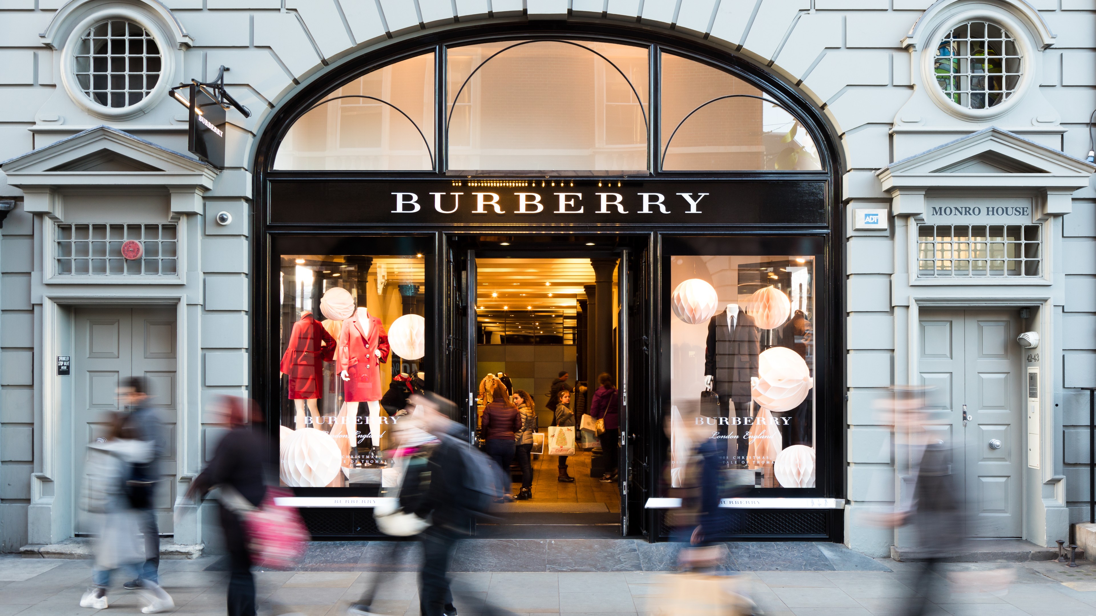 Shoppers walking past Burberry's Covent Garden store