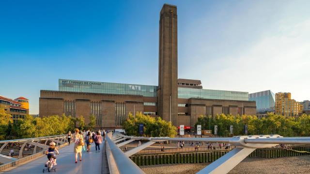 The Millennium Bridge leading to Tate Modern, London and Partners The steel Millennium Bridge in the foreground leading over the Thames river to red-brick Tate Modern against a blue sky