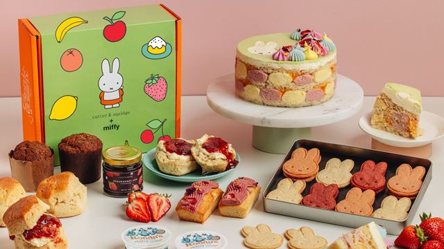 Miffy-themed afternoon tea spread with bunny-shaped biscuits, decorated cake, scones with jam and cream, and a branded Cutter & Squidge gift box.