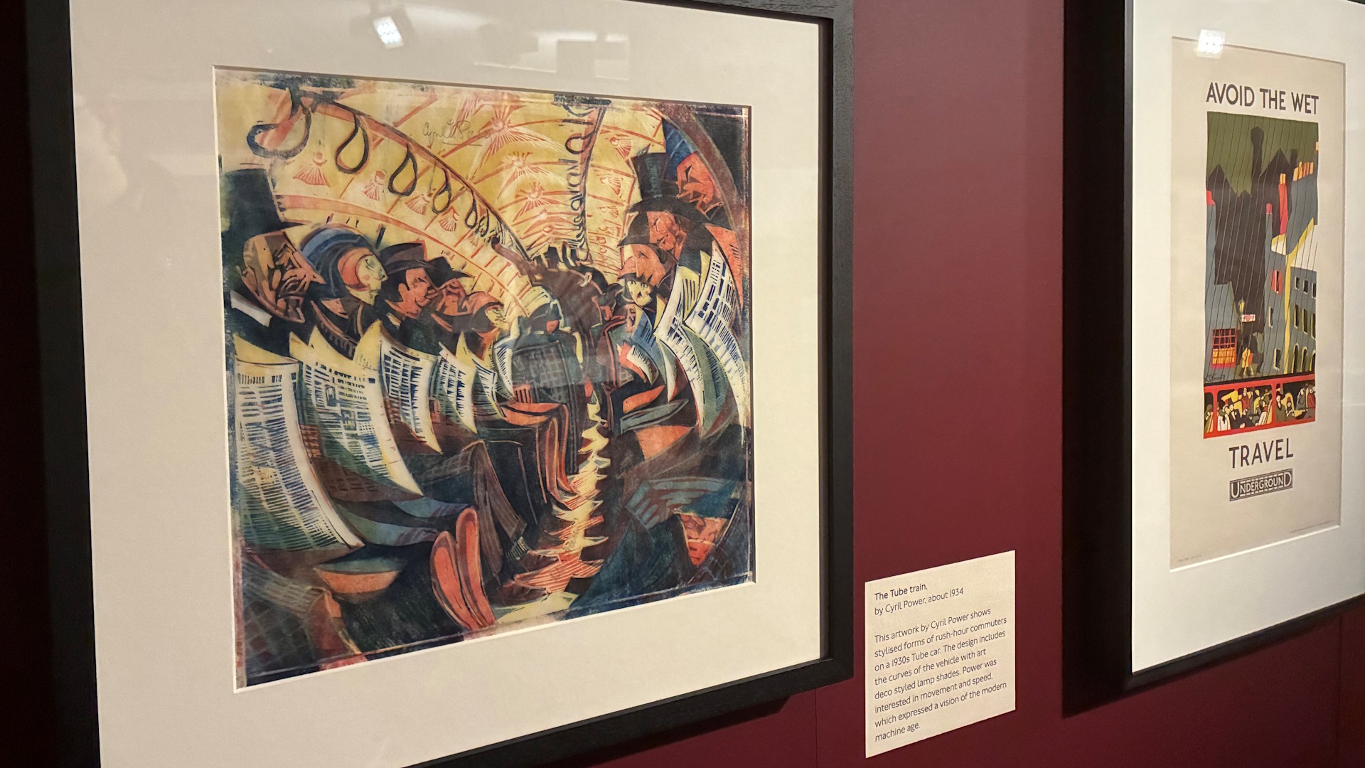 A framed artwork by Cyril Power showing commuters sitting on either side of the Tune train carriage, reading newspapers.
