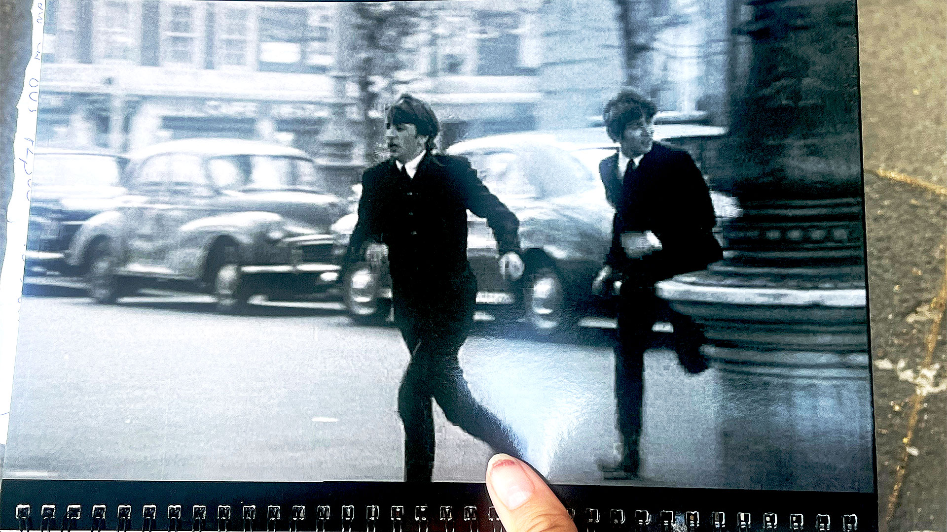 Photograph of one of the scenes from the film A Hard Day's Night, showing two members of the Beatles running through the streets of Marylebone near Boston Place.