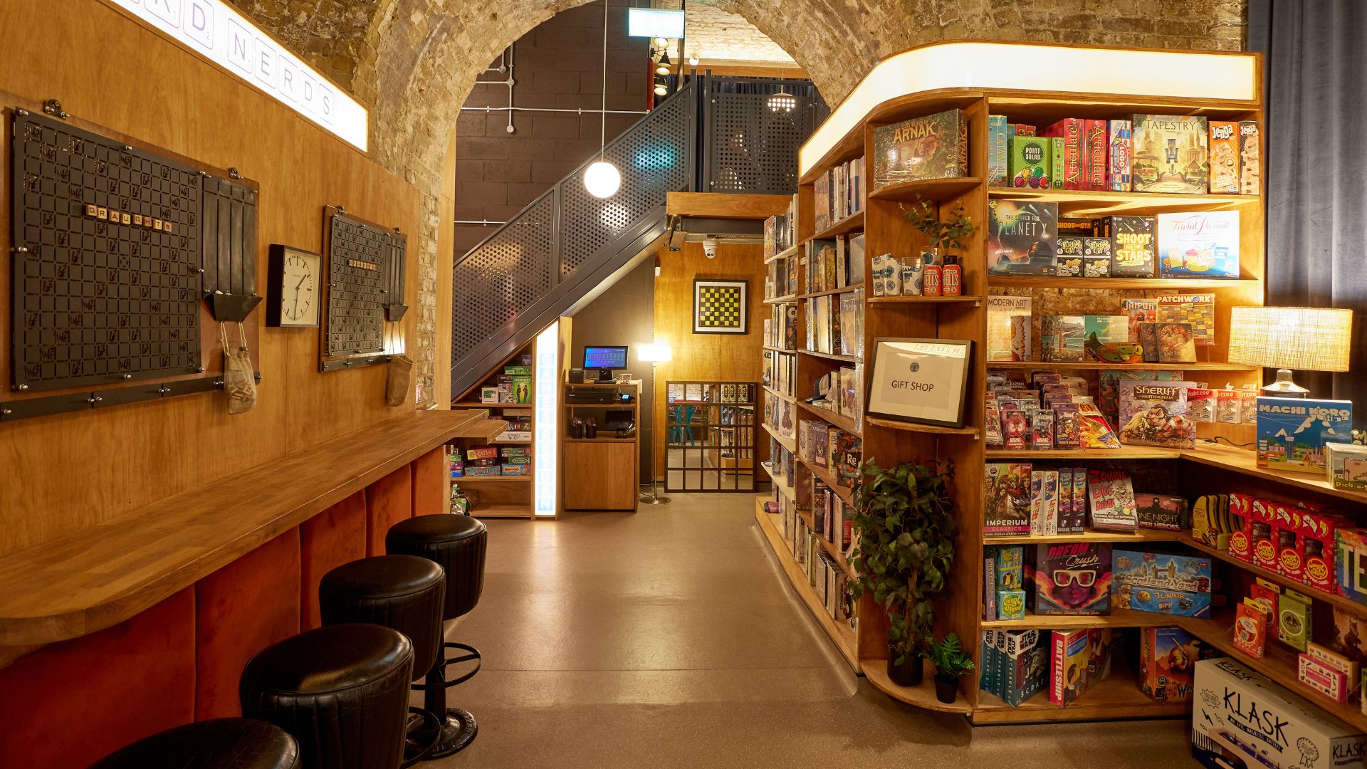 Interior of Draughts Waterloo with stool seating at the front and board game shelfs on the right hand side.