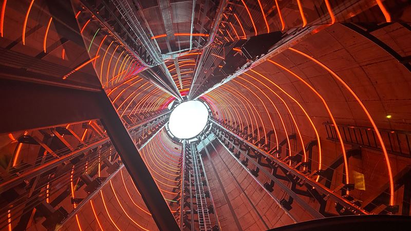 The interior of a chimney at Battersea Power Station lit up in red