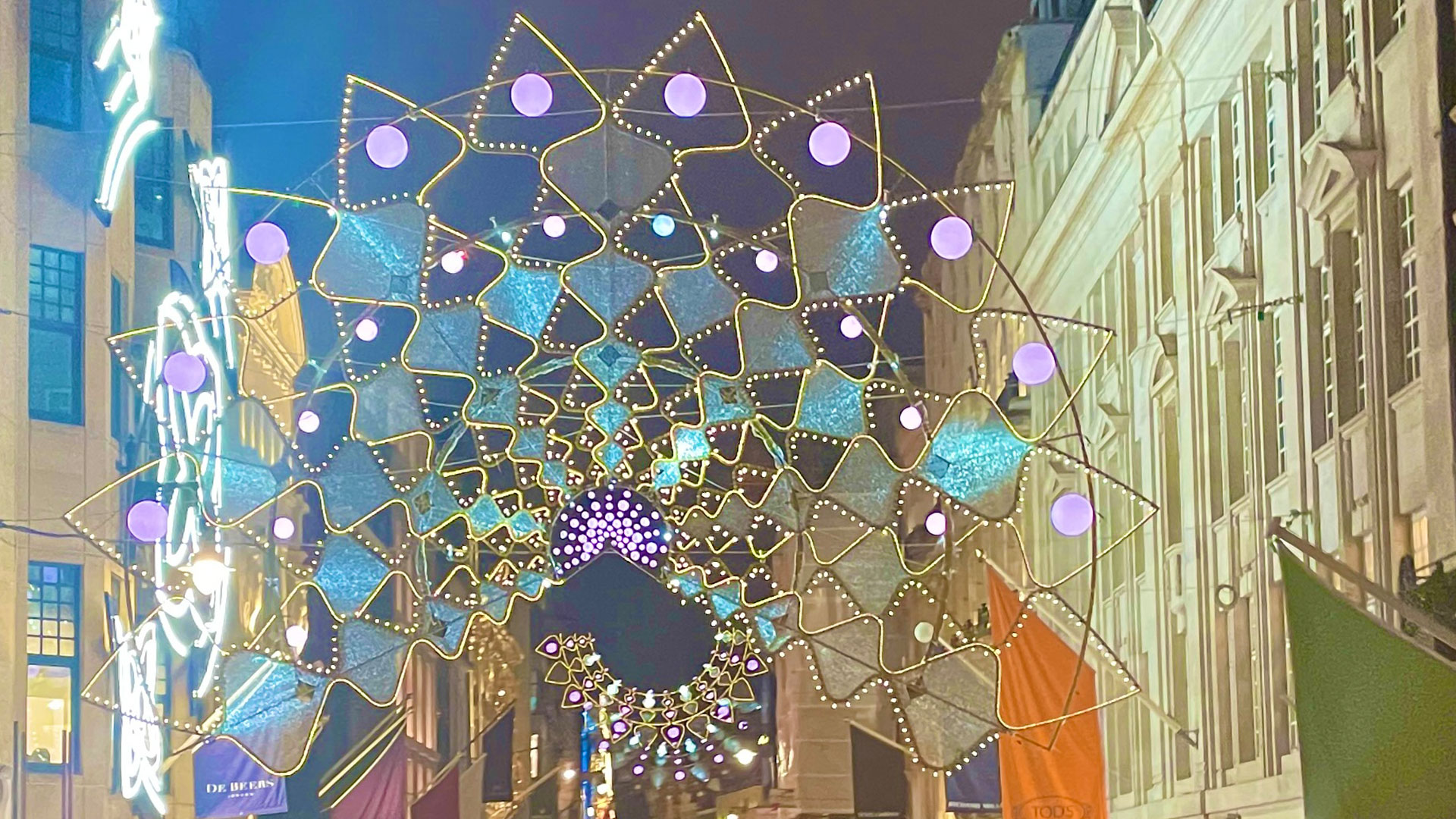 Colourful Christmas lights illuminating Bond Street in Mayfair at night