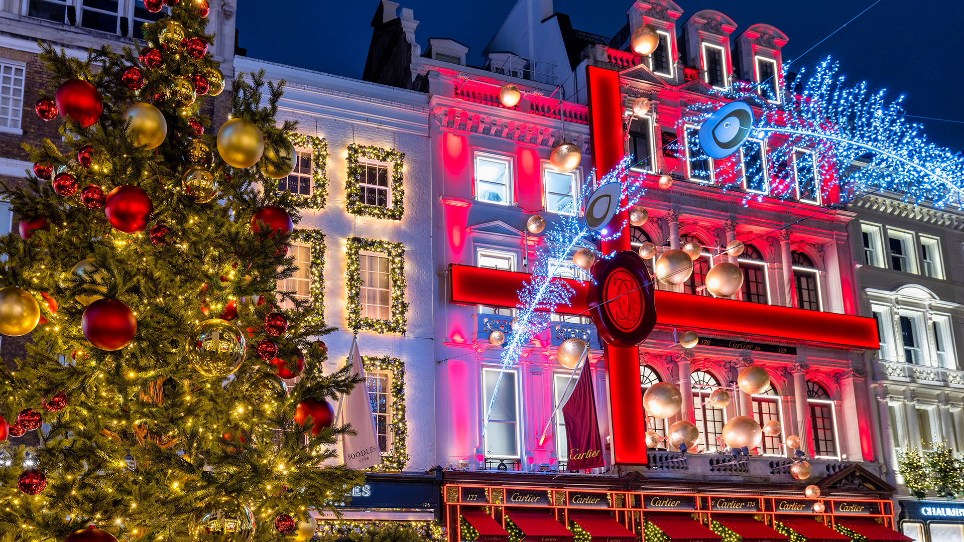 Bond Street in Mayfair has been dazzling visitors for decades with its Christmas lights. Image courtesy of Shutterstock. Bright and colourful Christmas window displays in Mayfair London.
