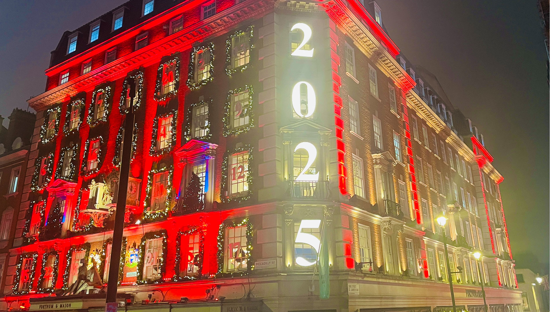 Fortnum & Mason's spectacular Christmas window displays © Chantal Welch. Image courtesy of Chantal Welch. Bright red and gold lights illuminate the front of Fortnum & Mason with each window representing an advent calendar door