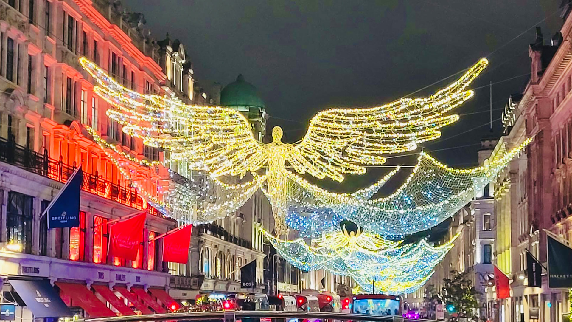 Regent Street's Spirit of Christmas angel lights © Natasha Pedersen. Image courtesy of Natasha Pedersen. Angel-shaped white and yellow lights hang above Regent Street at night.