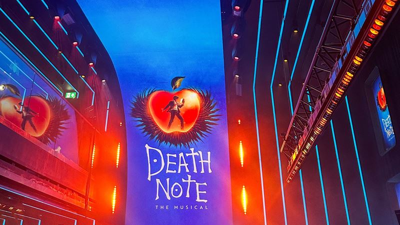 Death Note: The Musical promotional artwork displayed on large illuminated screens during the exclusive London preview event.