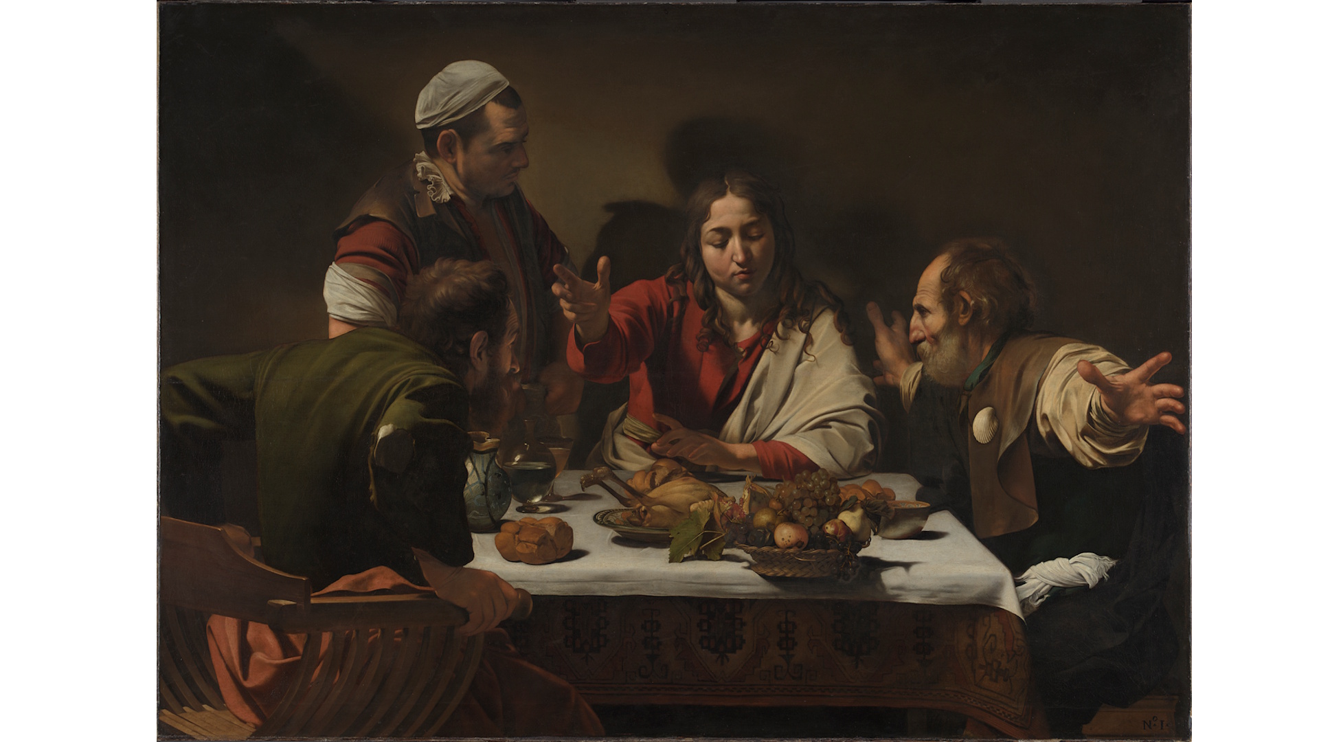 Caravaggio's The Supper at Emmaus, depicting four figures sit around a table with food on the table.