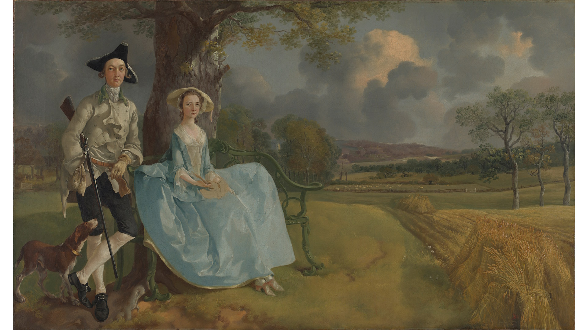 A man and woman dressed in elegant clothing sit facing the viewer, with their pastoral land in the background in Thomas Gainsborough's painting Mr and Mrs Andrews.