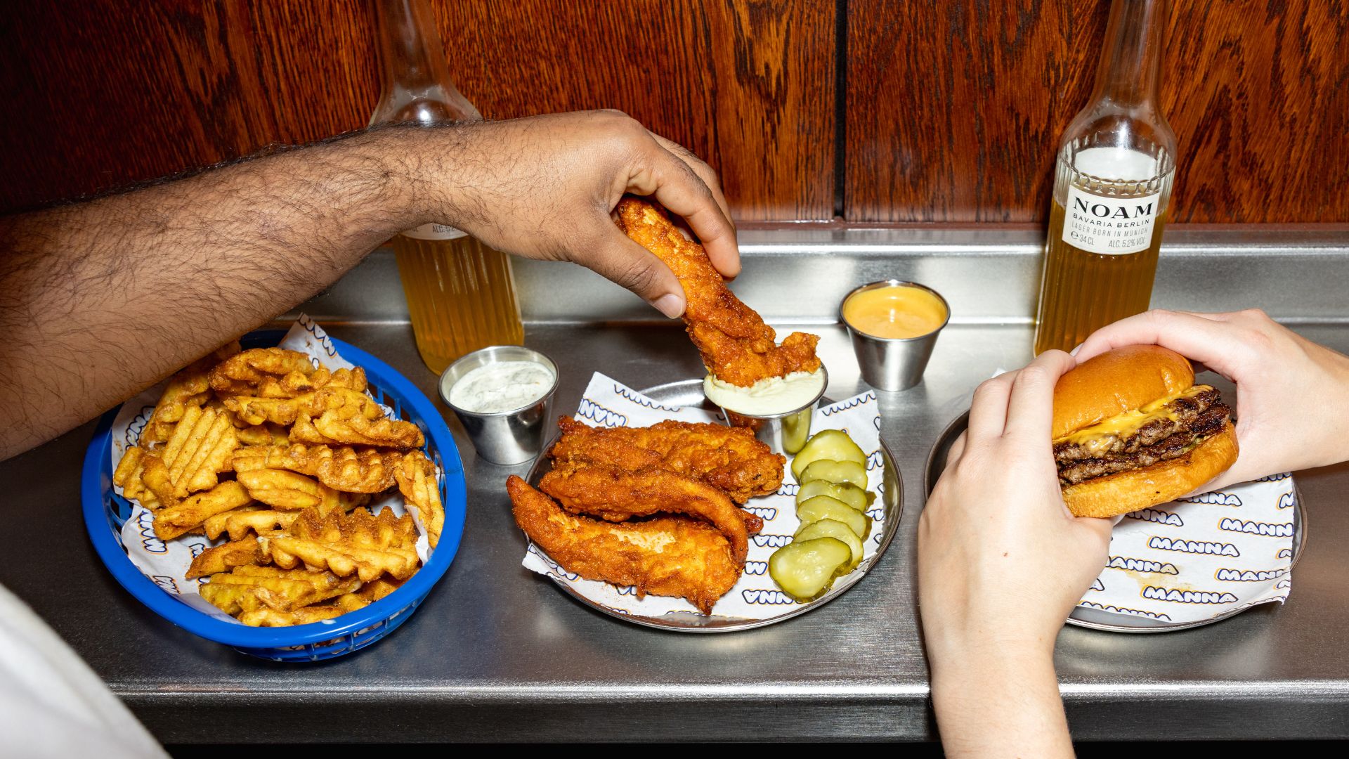 Chicken tenders, burgers, waffle fries and drinks served at Arcade Food Hall in London.