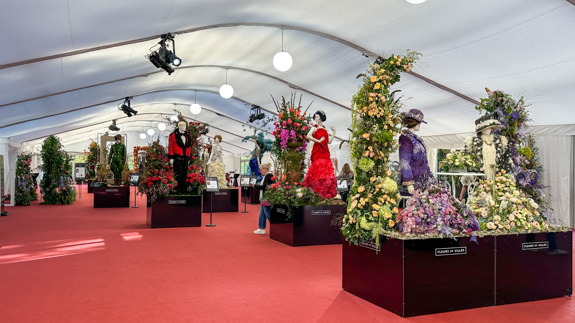 A long corridor in a marquee filled with flower mannequins at the Downton Abbey exhibition at Kew Gardens. 