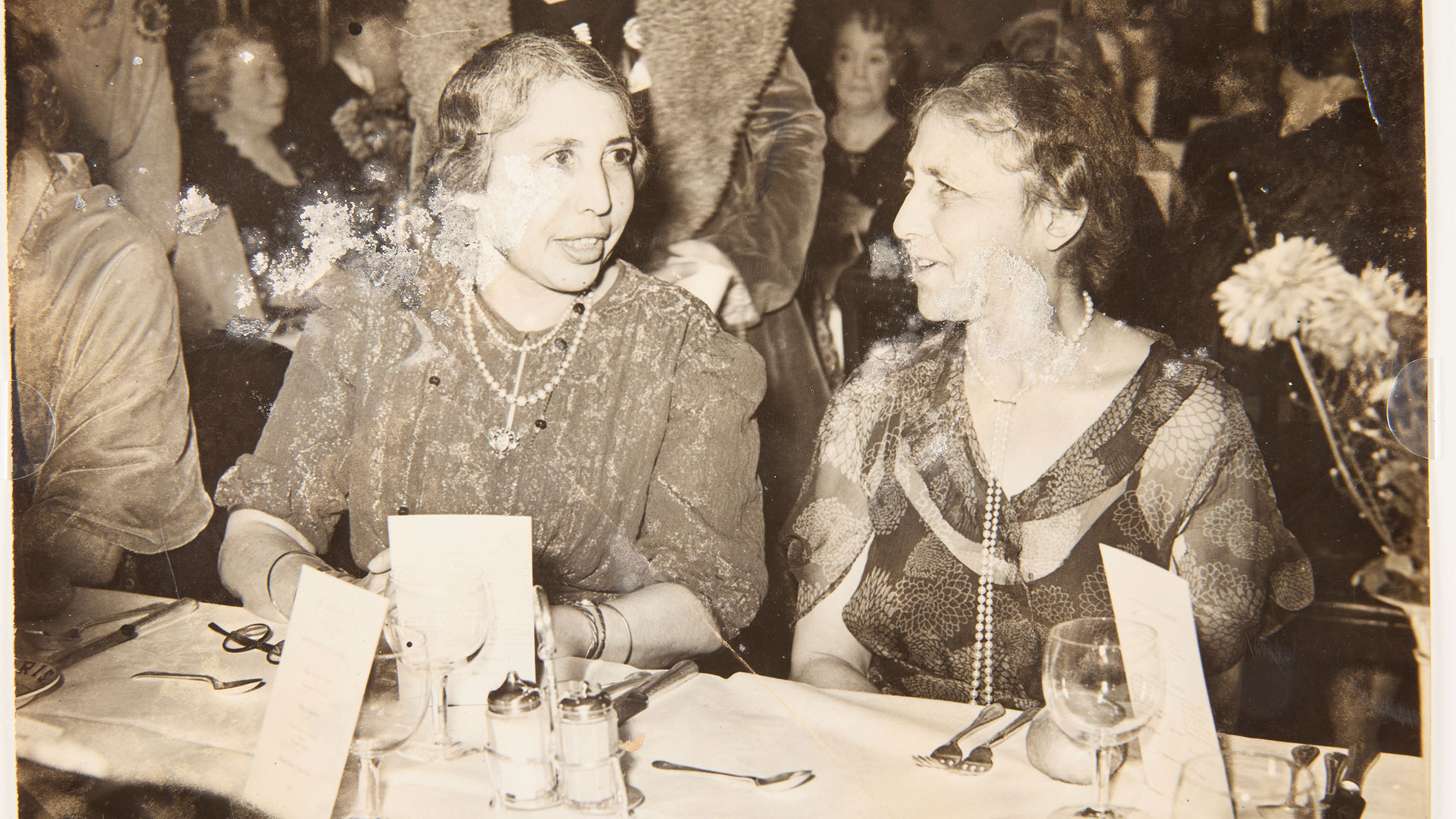Unmounted silver print photograph of Princesses Sophia and Catherine Duleep Singh at a Suffrage dinner on the anniversary of the first time Christabel Pankhurst and Annie Kenney were arrested in Manchester, 1930.