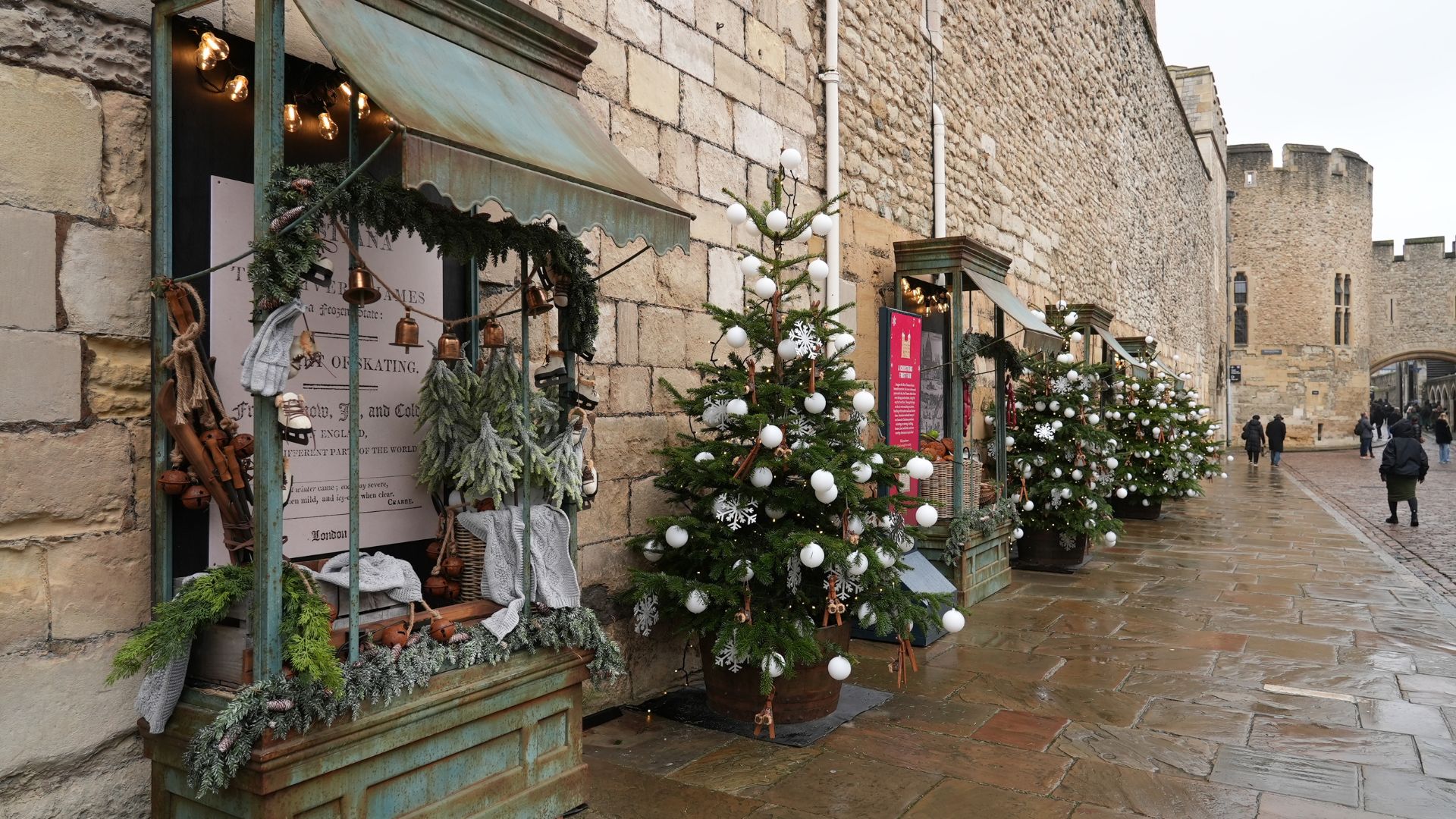 Enjoy this years Christmas celebrations and decorations at Tower of London. Image courtesy of Tower of London: © Historic Royal Palaces. The interior walls of Tower of London decorated with Christmas tress with white baubles.