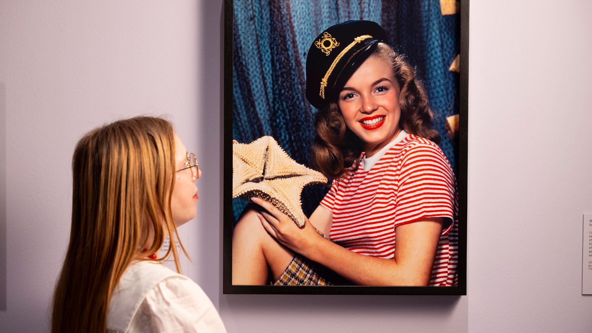A visitor observing Norma Jeane, 1946, by Bruno Bernard, in the exhibition Marilyn Monroe: A Portrait at the National Portrait Gallery, London.