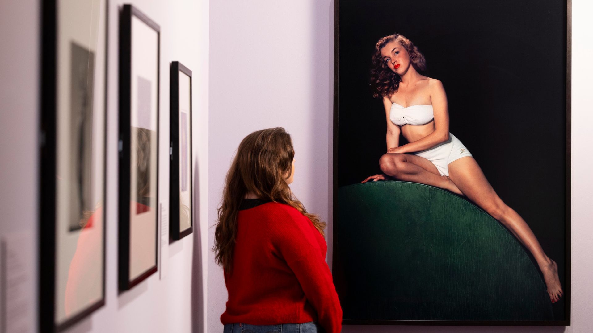 A visitor observing Norma Jeane Pin-up, 1946, by Bruno Bernard, in the exhibition Marilyn Monroe: A Portrait at the National Portrait Gallery, London.