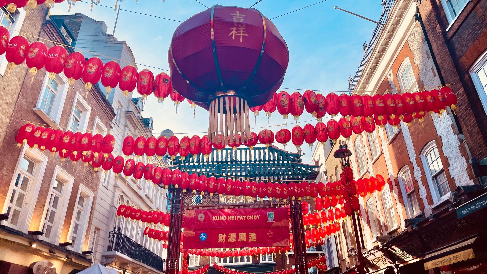 Red Chinese lanterns hanging acros the streets of Chinatown in London to mark Lunar New Year.