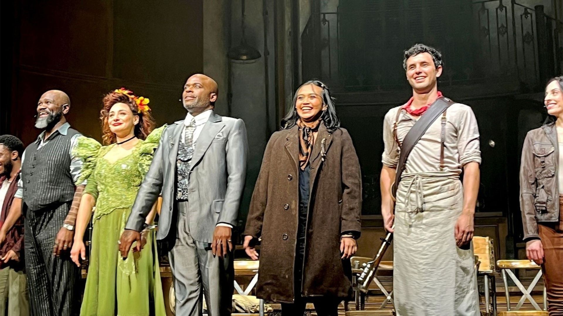 The cast of Hadestown stand and salute the Lyric Theatre audience, beaming with joy after their gala performance.