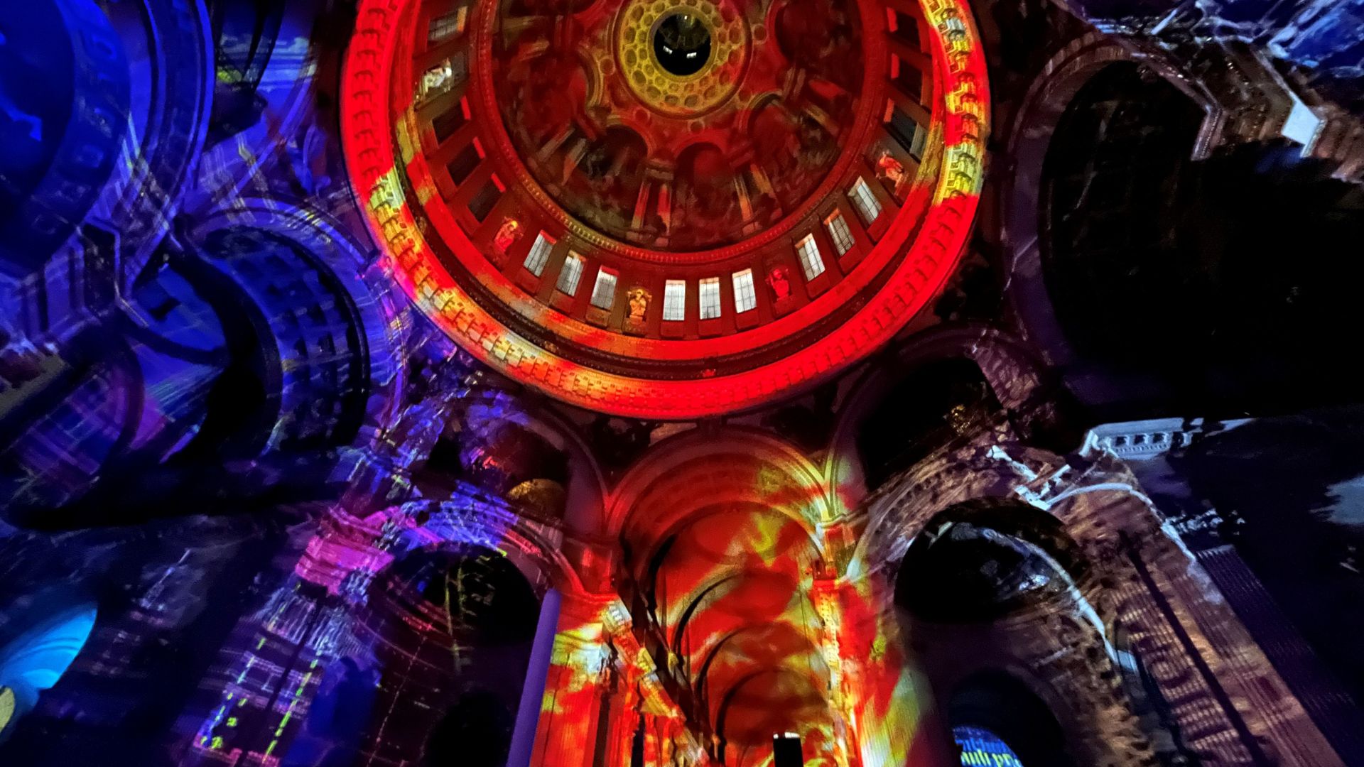 Red, yellow, purple and blue graphics illuminte the interiors of the galleries at St Paul's Cathedral as part of the 'Luminous’ installation by Luxmuralis.