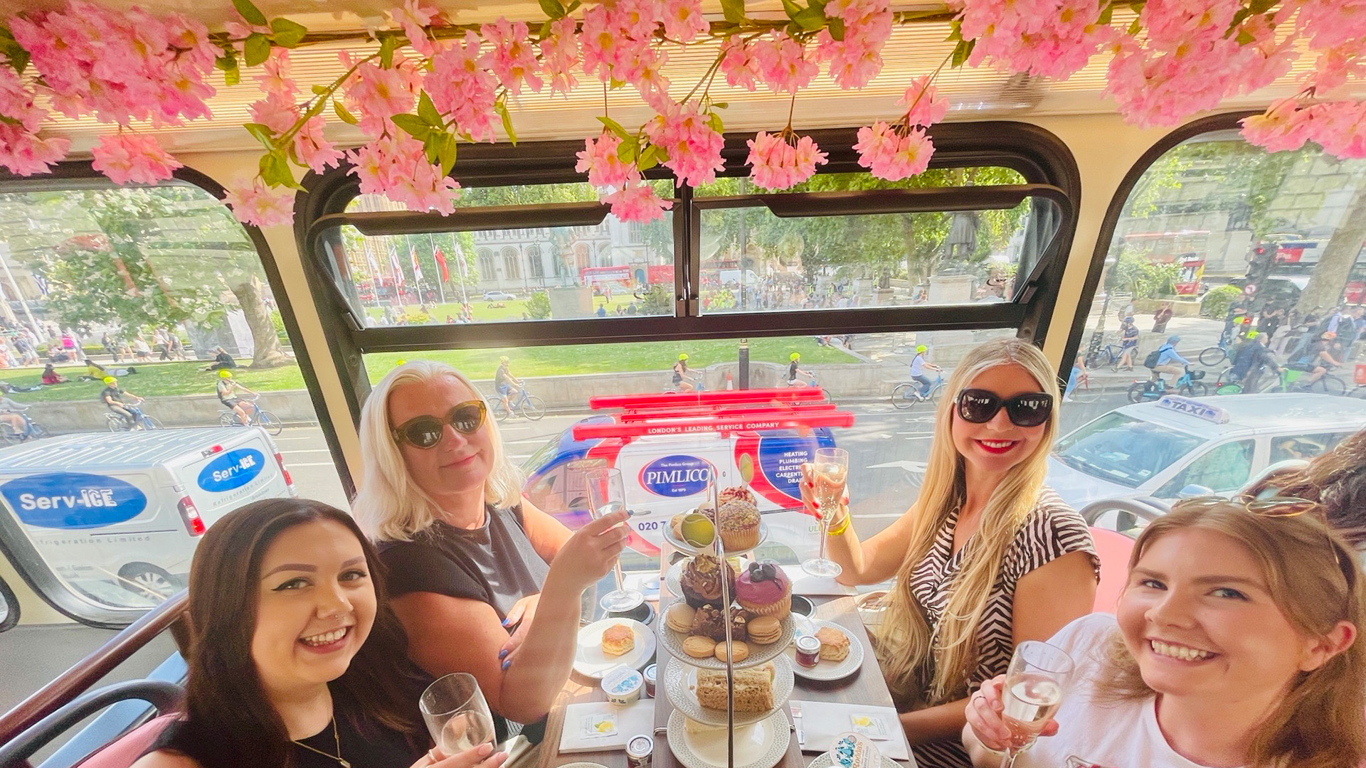 A group of women toasting on an afternoon tea bus tour