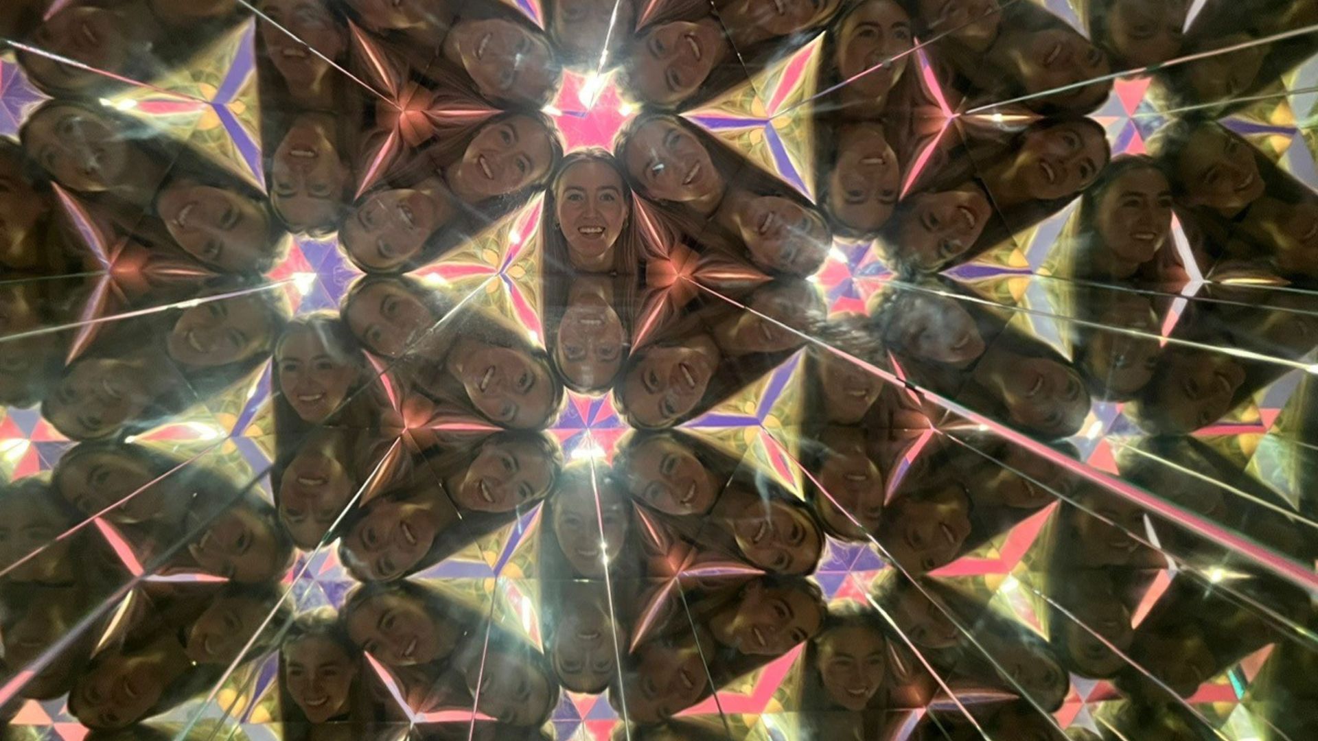 Look through the kaleidoscope of colour and snap mind-bending photos. © Visit London/Charlotte Pritchard. Multiple images of face with triangular shapes within a kaleidoscope.