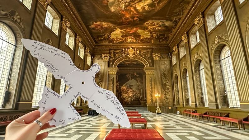 The Painted Hall at the Old Royal Naval College, with its ornate painted walls and ceiling and a paper dove installation in the foreground.