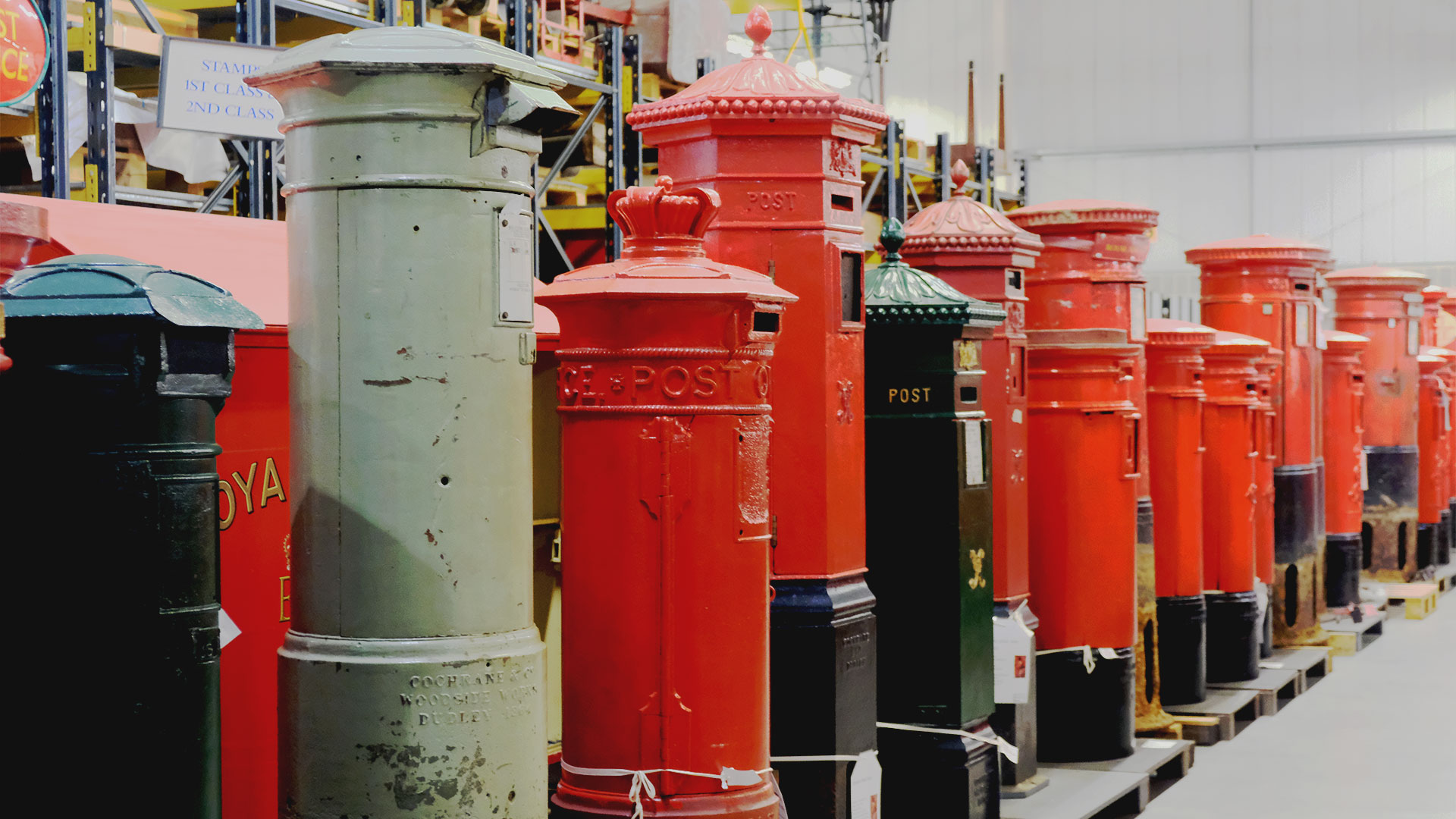 There is a long row of cast-iron post boxes, ranging in colour from dark green to light green and the iconic red.