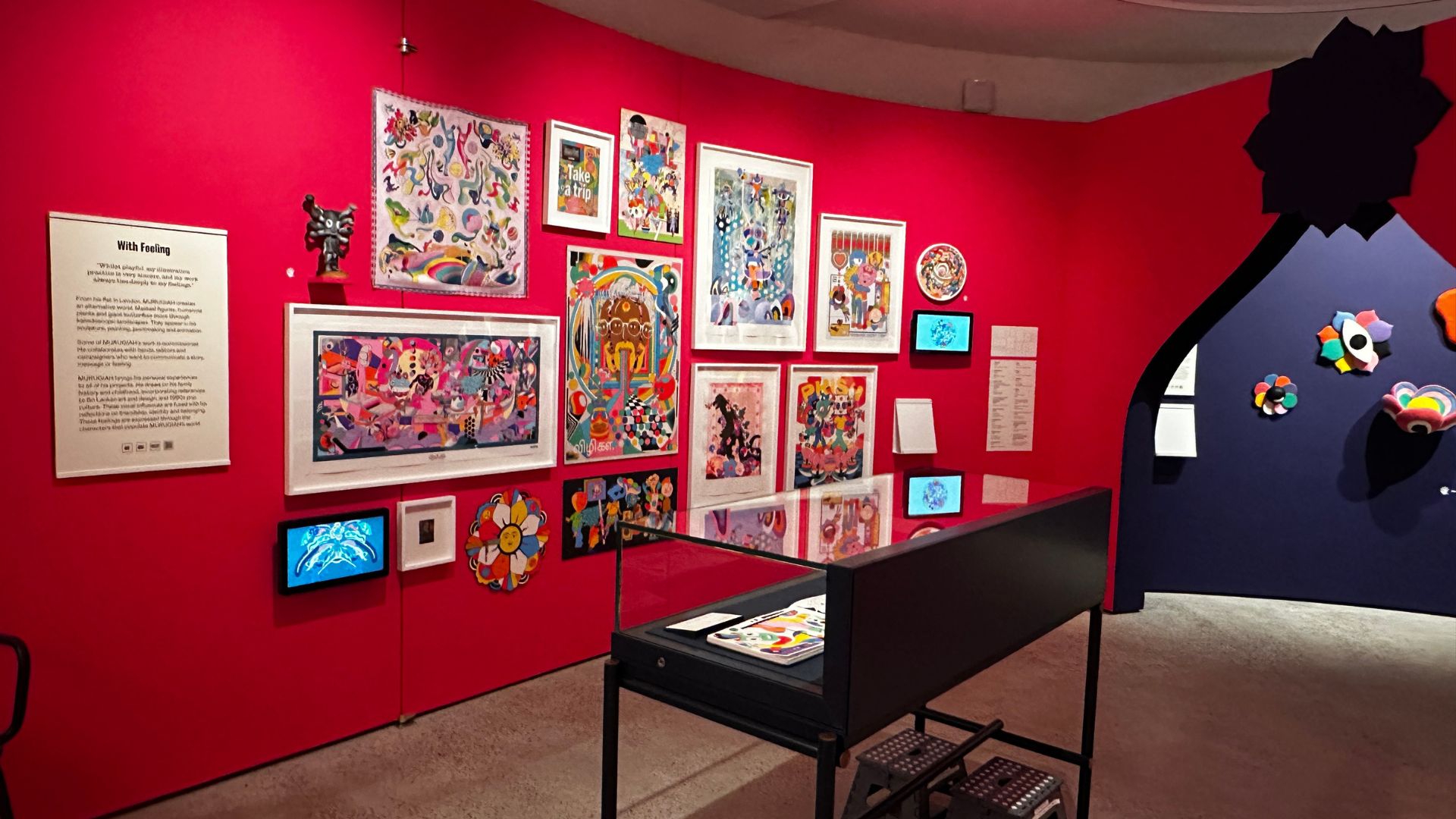 Bold colours, playful forms and powerful storytelling come together in MURUGIAH: Ever Feel Like..., the artist's first solo exhibition exploring identity, belonging and creativity. Photo Credit: Kirstine Spicer/Visit London. Colourful installation and artworks by MURUGIAH displayed against vibrant pink and navy gallery walls at the Quentin Blake Centre for Illustration.