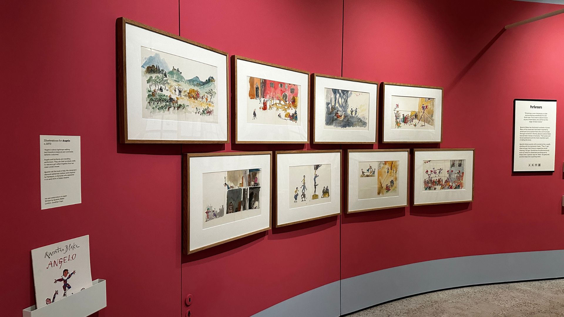 Original artwork from Angelo showcases Quentin Blake's gift for bringing stories, movement and personality to life through illustration. Photo Credit: Kirstine Spicer/Visit London. A selection of Quentin Blake's original illustrations for Angelo displayed on a curved pink gallery wall.