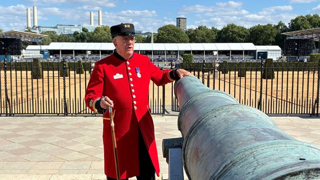 Bill Horsburgh, a Chelsea Pensioner and tour guide, leans on one of the cannons within the grounds of Royal Hospital Chelsea.