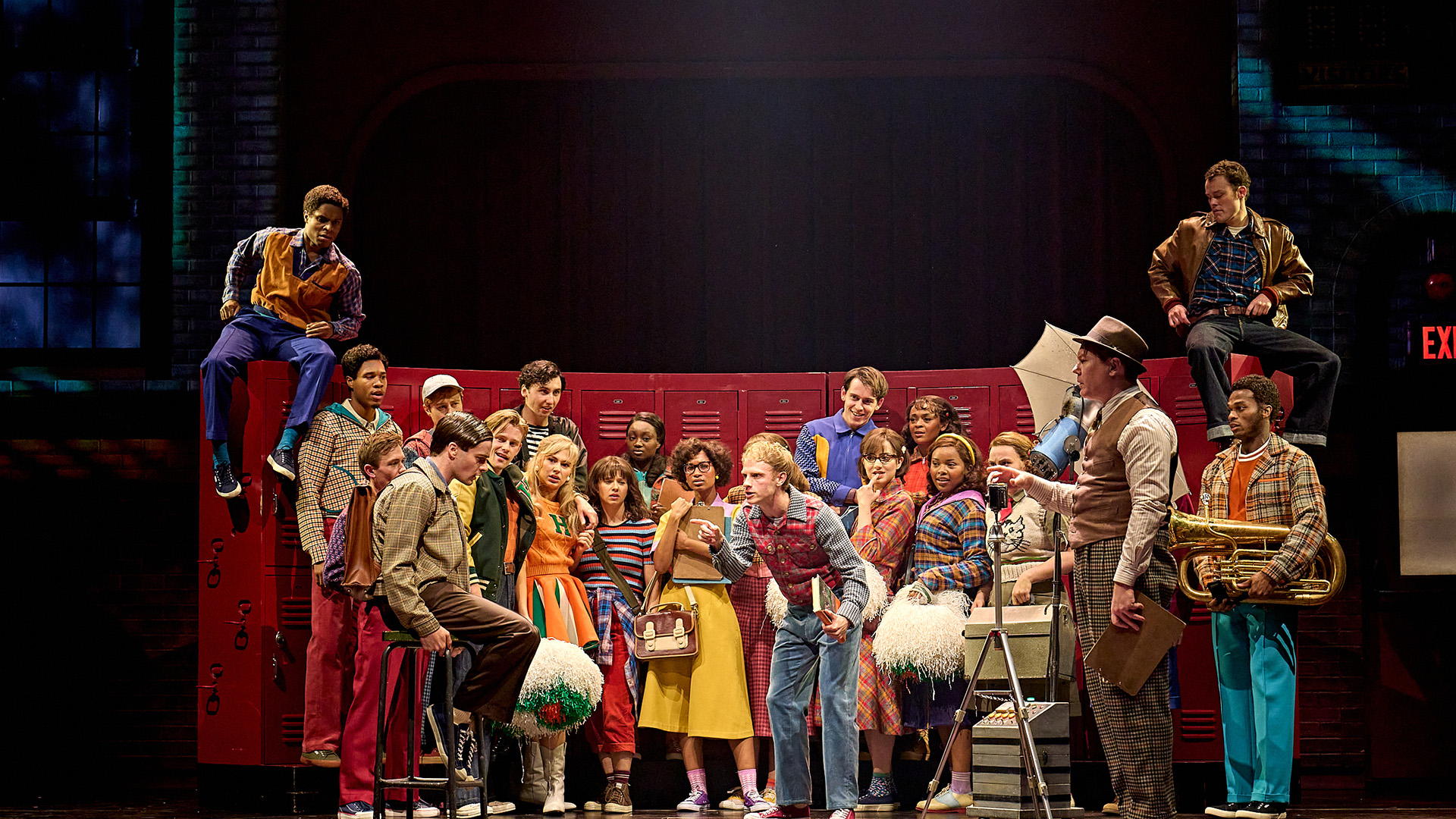 Enjoy the play Stranger Things: The First Shadow at the Phoenix Theatre in London. Image courtesy of London Theatre Direct The cast of Stranger Things: The First Shadow stand in front of red school lockers.