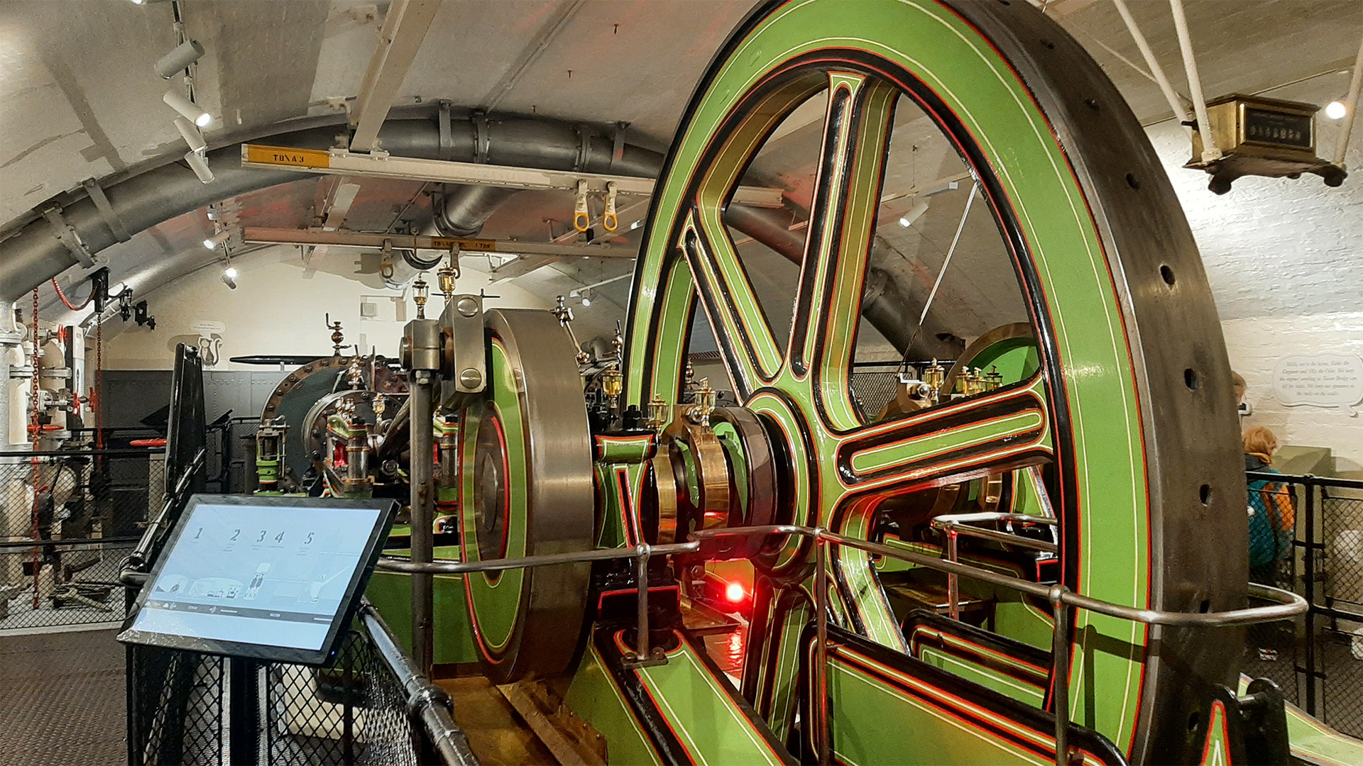 One of the steam engines inside the engine rooms exhibition painted green and red.