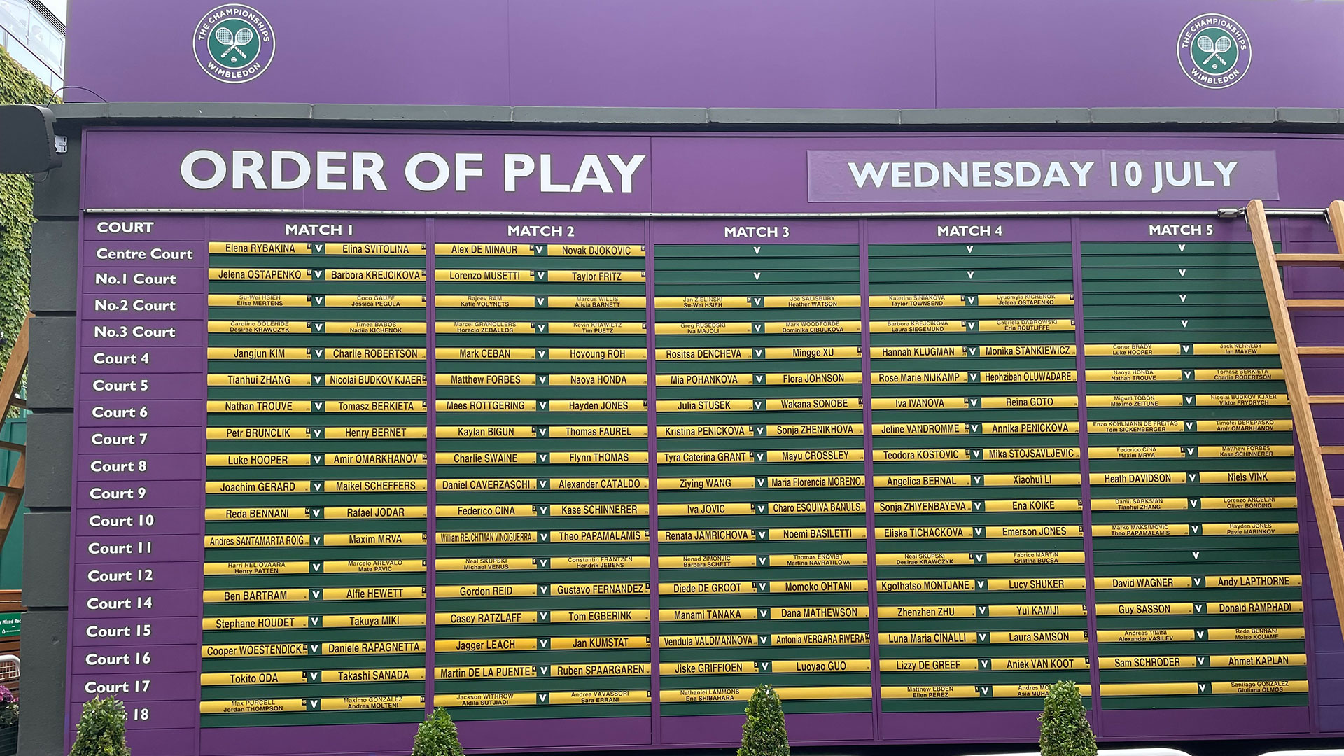 Plan your day at Wimbledon by checking the order of play boards in the grounds (image taken in 2024). Image courtesy of Chantal Welch. A purple order of play board at Wimbledon